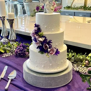 wedding cake with purple flowers
