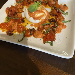 Roasted tomato, garlic and basil surrounding burrata. Drizzled with creamy vodka sauce