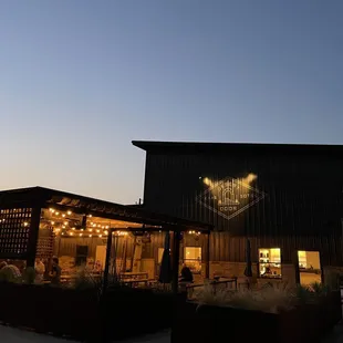 the outside of a restaurant at dusk