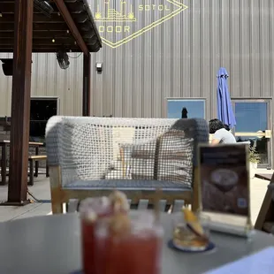 a table with drinks and a laptop