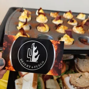 a person holding a tray of food