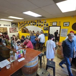 a crowd of people sitting at the bar