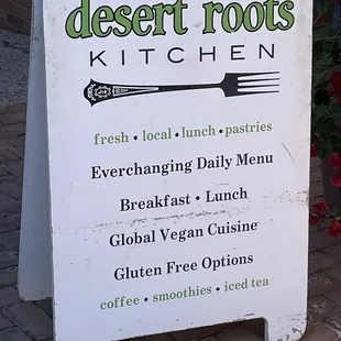 a sign for desert roots kitchen