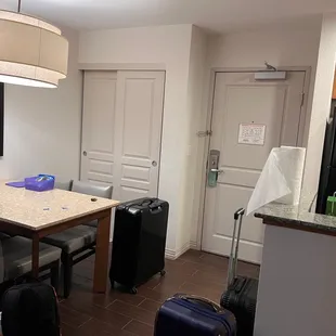 Dining area, small closet with iron and iron board and storage, Kitchenette