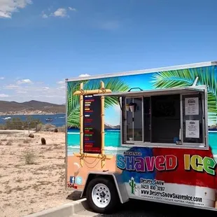 a colorful food truck parked on the side of the road