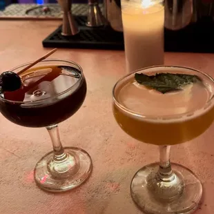 two cocktails on a bar