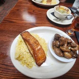 Pan seared salmon with rice and sauteed mushrooms.