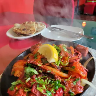 Garlic Naan and tandoori chicken, steam still coming off the plate YUM