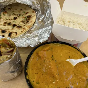 Chicken curry homestyle, garlic naan, biryani rice and chicken kathi roll. So delicious. Dip that naan in the curry!