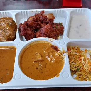 Buffet plate with Lamb rogan josh, chili chicken, raita, Dal makhani