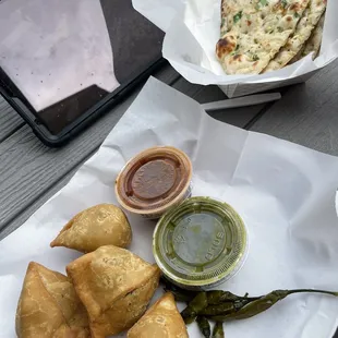 Some desi bites as the name says. Veggie samosas (Med spice) and garlic naan (no spice)