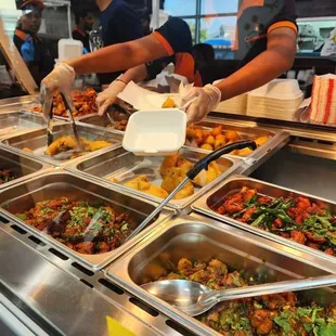 a person serving food at a buffet