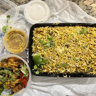 a tray of rice and a bowl of vegetables
