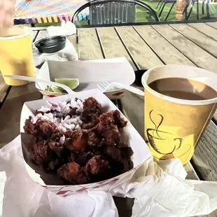 a basket of food and a cup of coffee