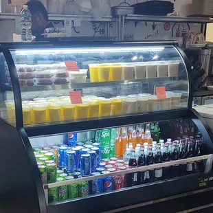 a refrigerated display case filled with drinks