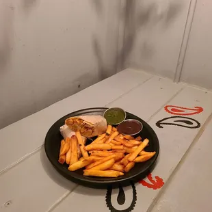 a plate of french fries and a sandwich