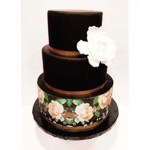 ws a three tiered cake with a flower on top