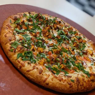 a pizza on a wooden platter