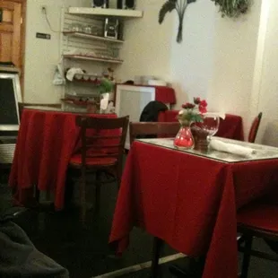 a dining room with red tablecloths