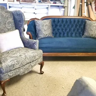 Tufted back upholstered sofa with contrast pillows to match complementary wing back chair