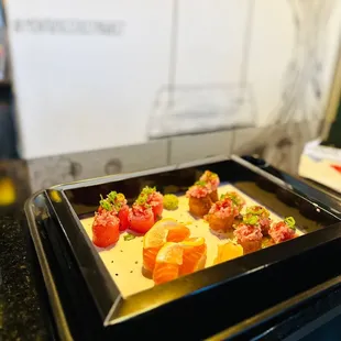 a plate of sushi and a bottle of water