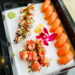 a variety of sushi on a white plate