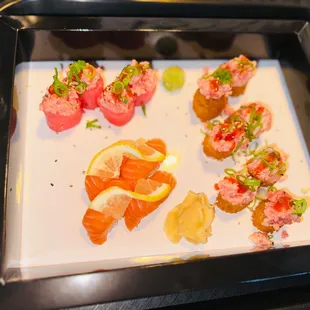 a variety of sushi on a white plate