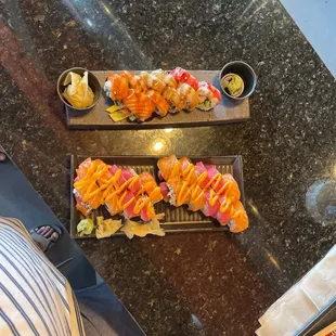 two trays of sushi on a table