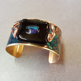 Brass, fused glass and patina copper 1.5 inches wide.