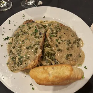 Chicken piccata on a bed of linguine in a delicious creamy capers, butter, lemon sauce