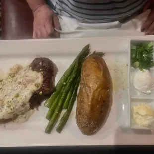 NY 12 oz. New York Striploin with Blue Cheese and a giant potato and asparagus.