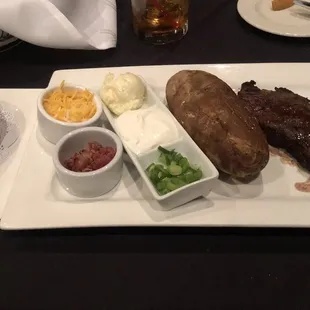 New York Steak with (extra) peppercorn sauce and loaded baked potato.