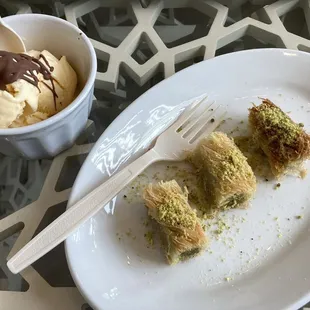 vanilla ice cream with chocolate on top, and a serving of 3 piece pistachio baklava