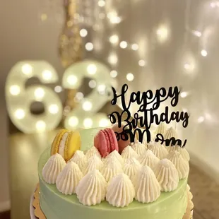 a birthday cake with macarons on top