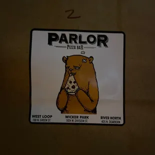 a sticker of a bear eating a piece of pizza