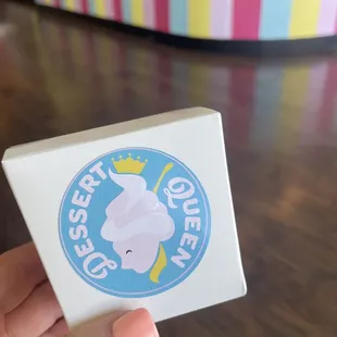a hand holding a box of ice cream