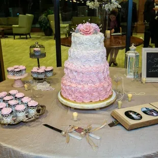 a wedding cake and cupcakes