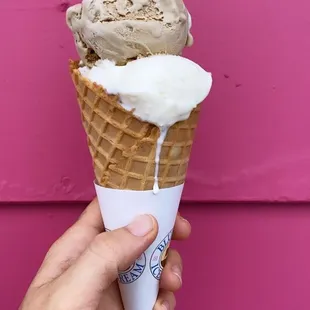 a hand holding an ice cream cone