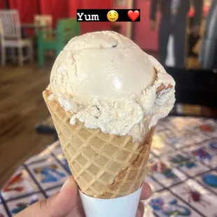 a hand holding an ice cream cone