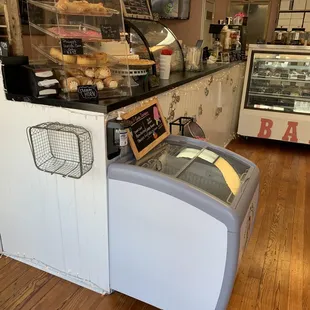 a bakery counter with a display of pastries