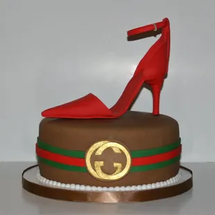 a gucci shoe on top of a cake