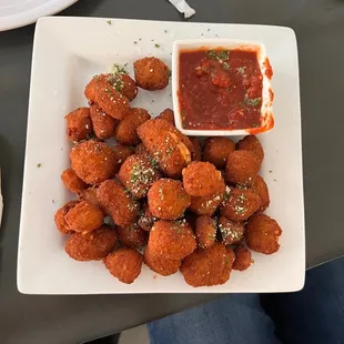 a plate of food with dipping sauce