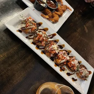 two plates of appetizers and a glass of wine