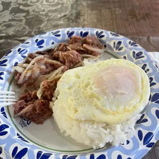 Corned beef with onions, one scoop rice and one egg over easy.