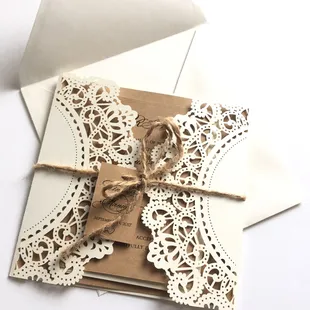 Lasercut gatefold with Kraft cardstock invitation, RSVP card and twine bow.