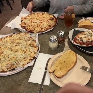 a table full of pizzas