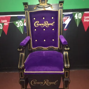 a purple chair with a crown on it