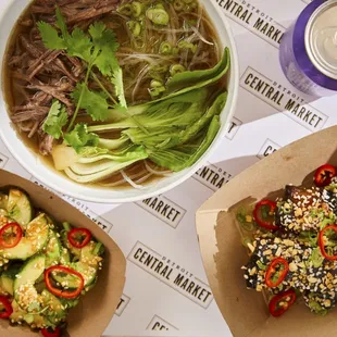 a bowl of soup, a bowl of salad, and a bowl of noodles