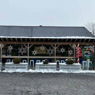 the outside of a store with snowflakes on the roof