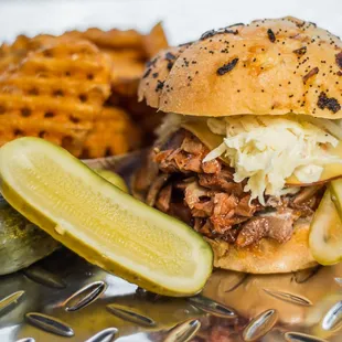 #9 BBQ Pork sandwich with a side of waffle fries. House-roasted pork in our homemade BBQ sauce w/ smoked gouda, coleslaw, and sl